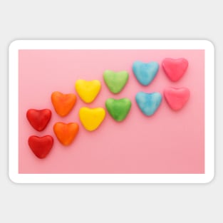 Heart-shaped Candy arranged in rainbow order on a pink background Sticker